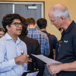 A student discusses internships and job opportunities with Sentry Insurance.