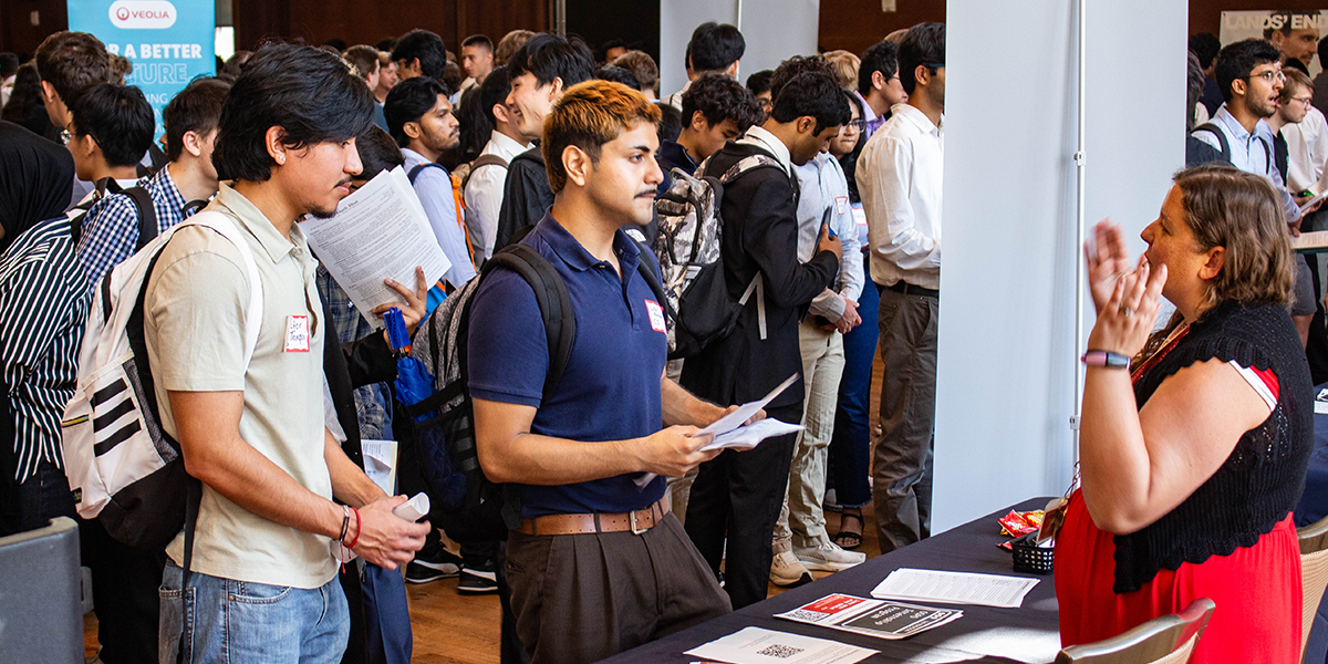Students discuss how to find internships successfully with recruiters at the CDIS Career Fair on September 17, 2025.