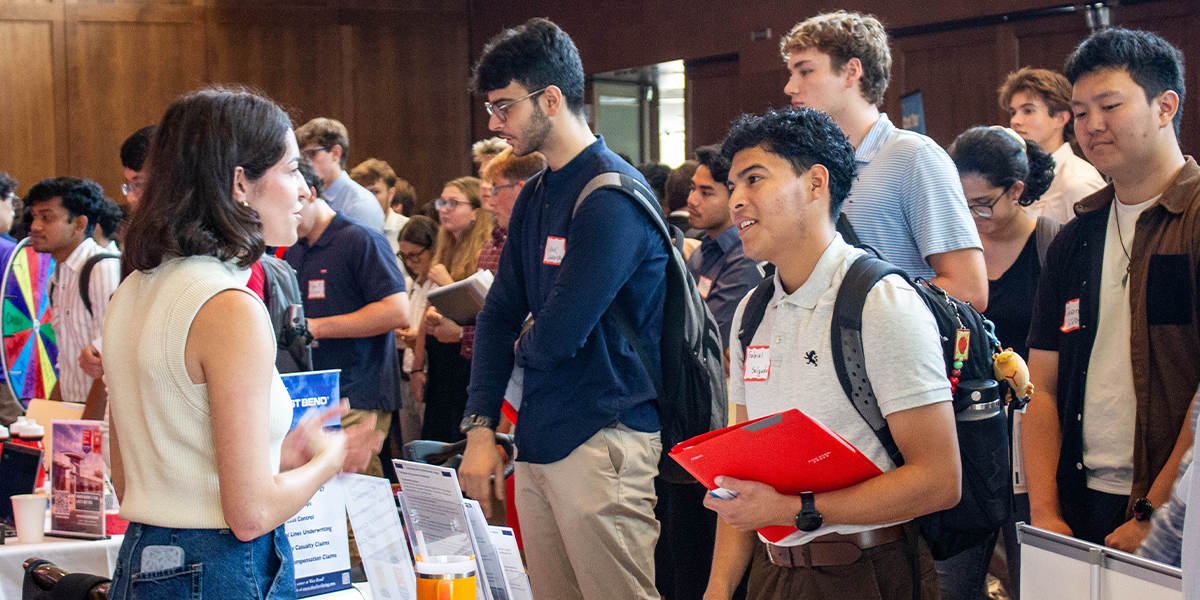A student discusses how to get an internship with an employer at the CDIS Career Fair on September 17, 2025.