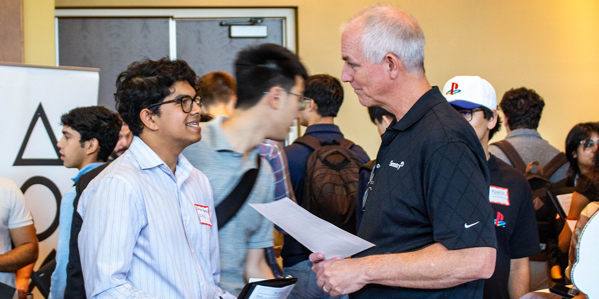 A student discusses internship opportunities with Alvin Menninga, a software engineering manager at Sentry Insurance.