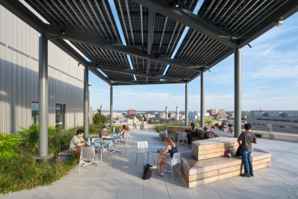 Photo of people working on the 7th floor terrace of Morgridge Hall