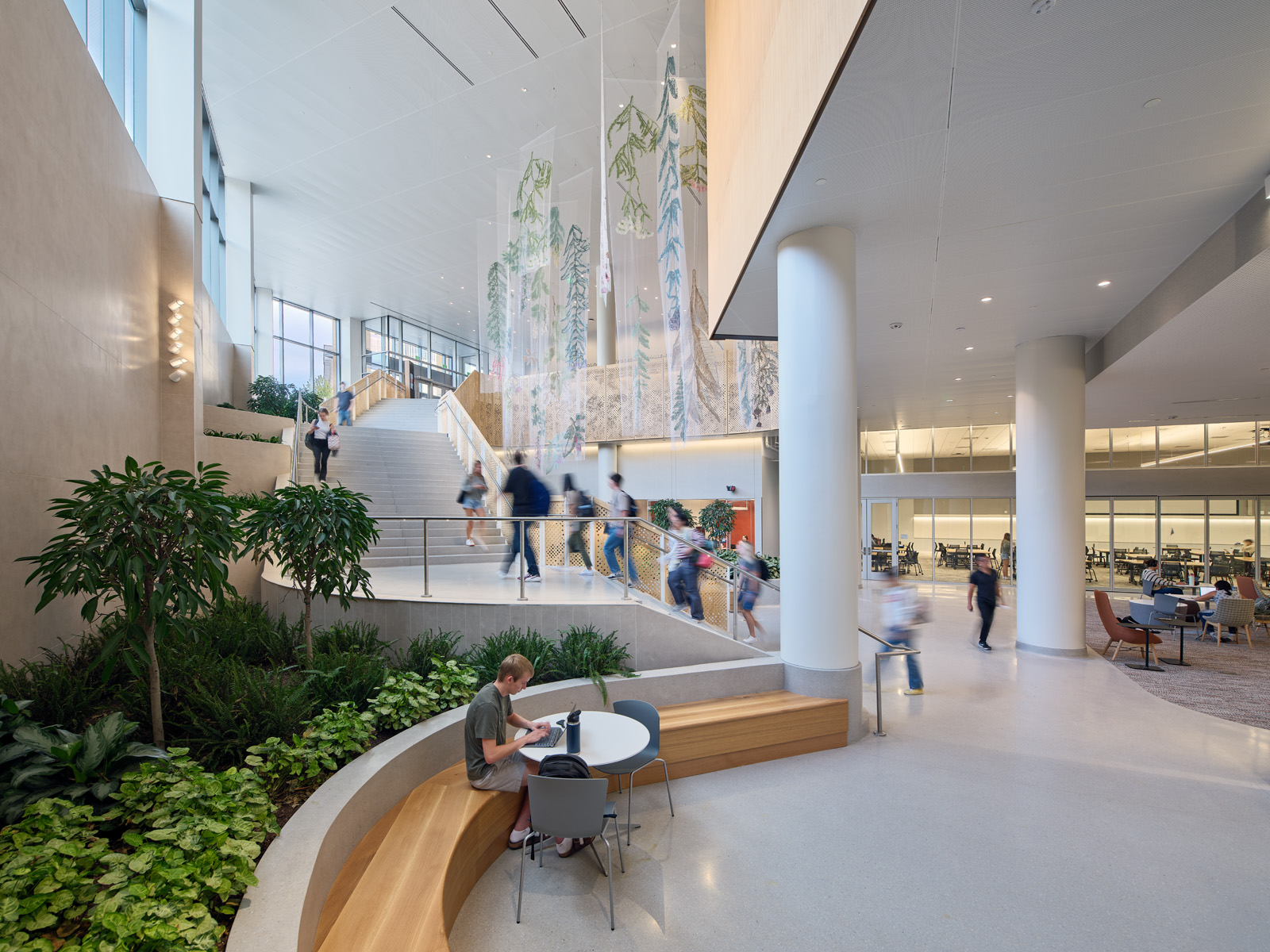 People walking on the stairs of the basement level of Morgridge Hall