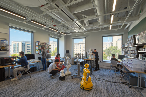 Photo of people in a lab working on robots