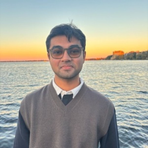 Person by lake at sunset